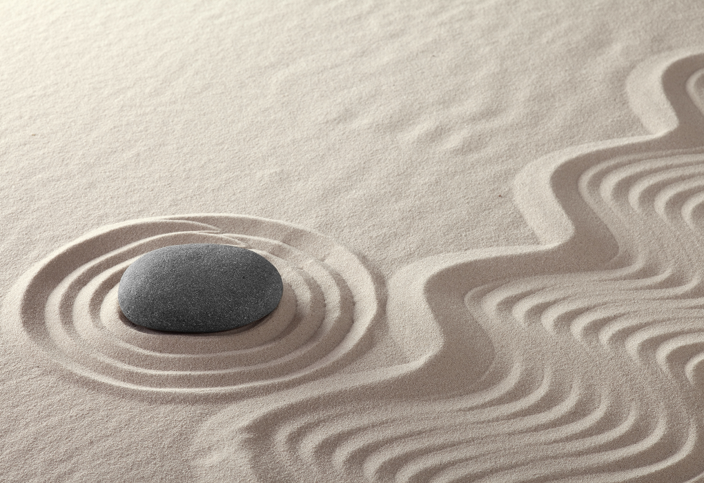 a stone in the sand with rings around it