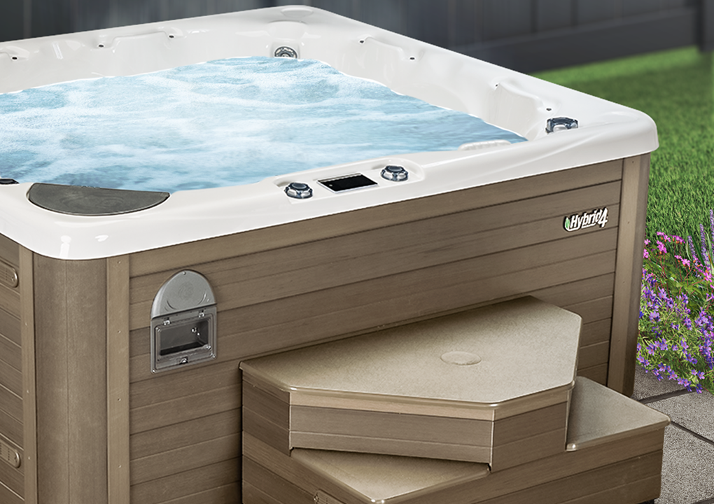 beachcomber hybrid4 hot tub with small grass patch in background