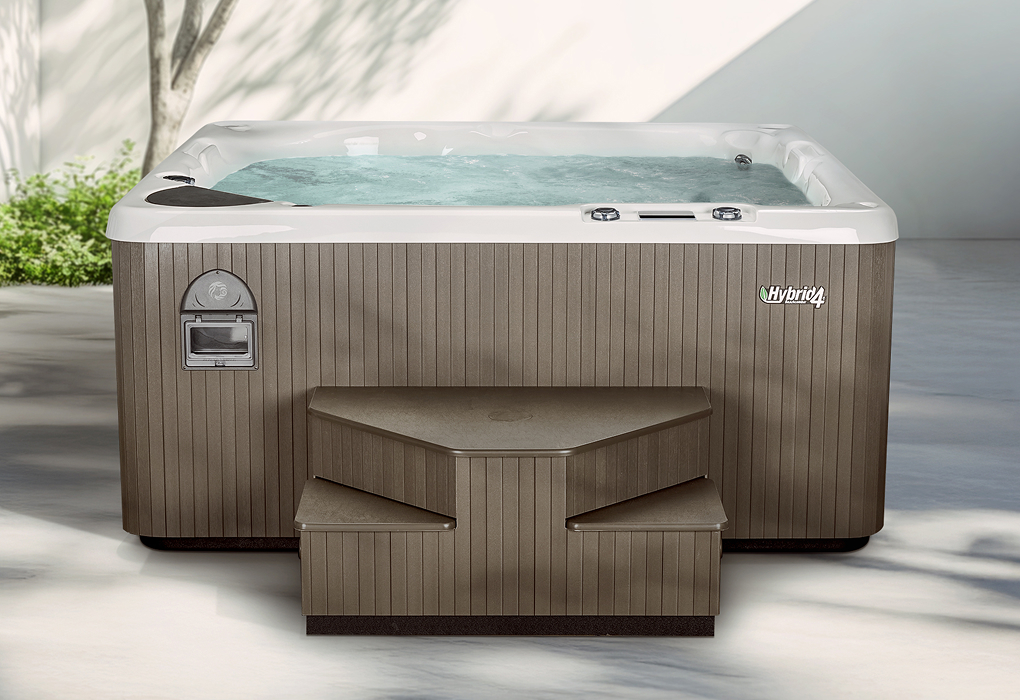 beachcomber hybrid4 hot tub in backyard with sunlight cutting across