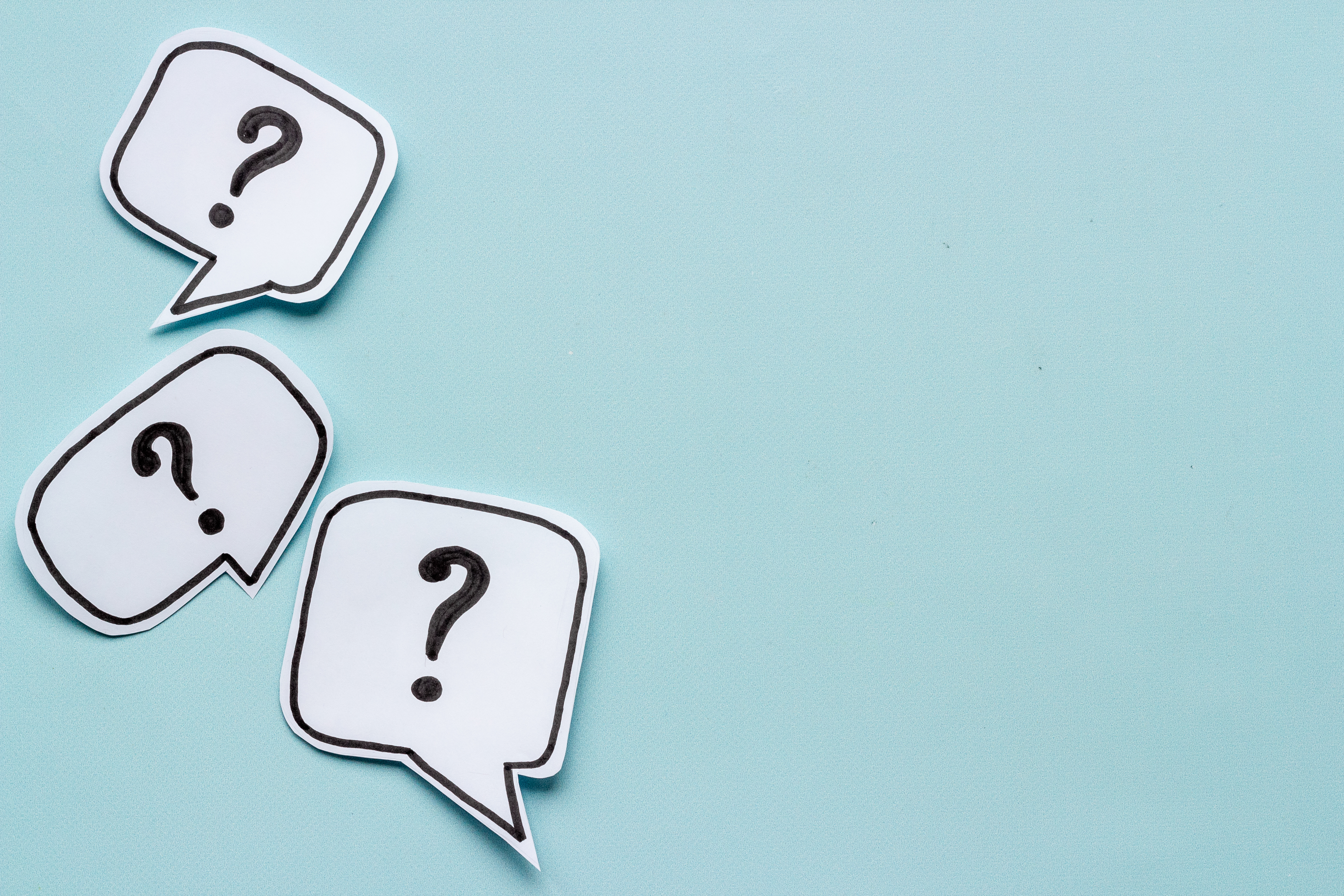 blue background with three question marks in the bottom right corner
