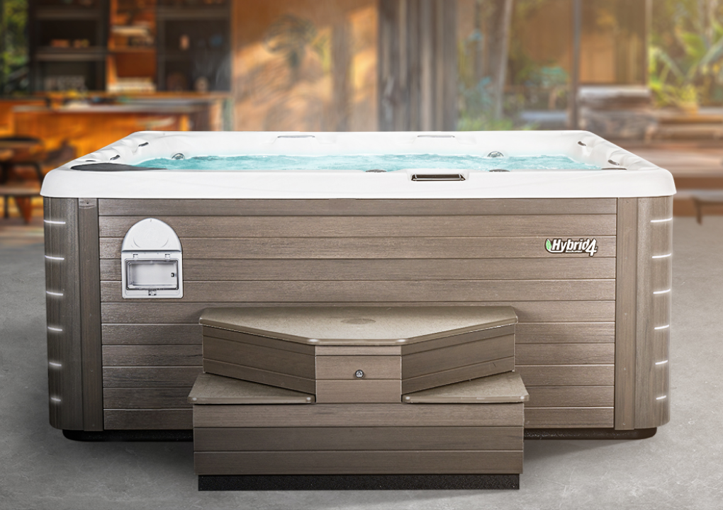 beachcomber hot tub with a blurred backyard background