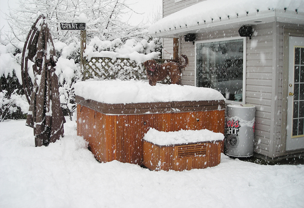 beachcomber hot tub in a snowy backyard