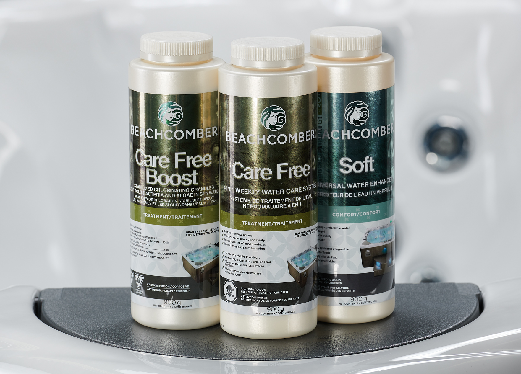 three bottles of water care product by beachcomber hot tubs. care free boost, care free, and soft. sitting on the tray of a beachcomber hot tub