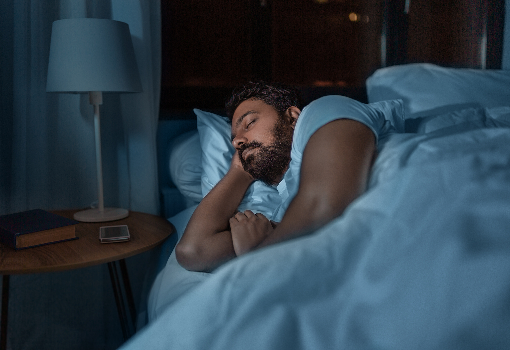 person lying on their side in bed sleeping
